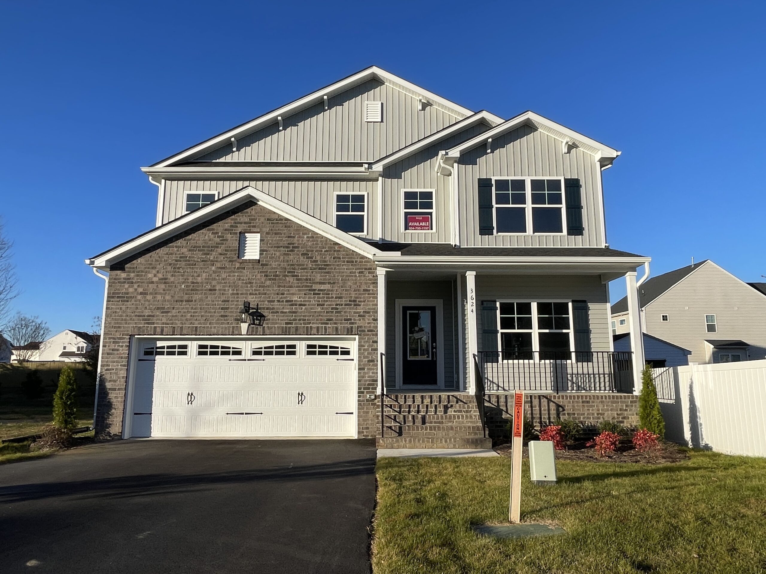 Elmsted B elevation with brick accent by Boyd Homes.